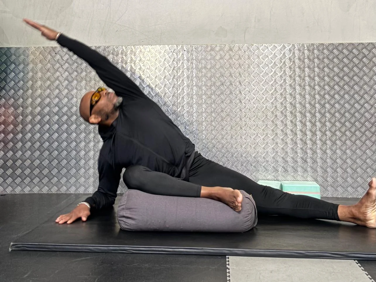 Chris practising a supported side stretch at Fitness 4 Less